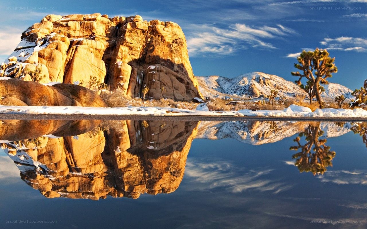 Snowy desert landscape with reflection