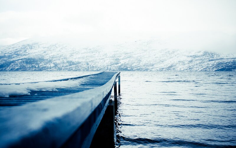 Snowy dock on a lake