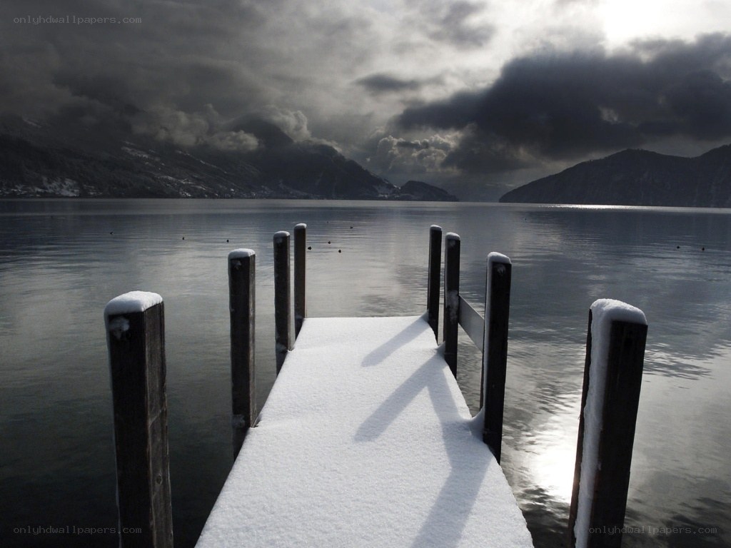 Snowy dock on a lake