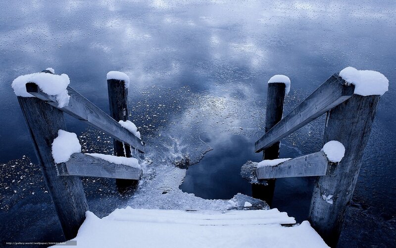 Snowy dock on frozen lake