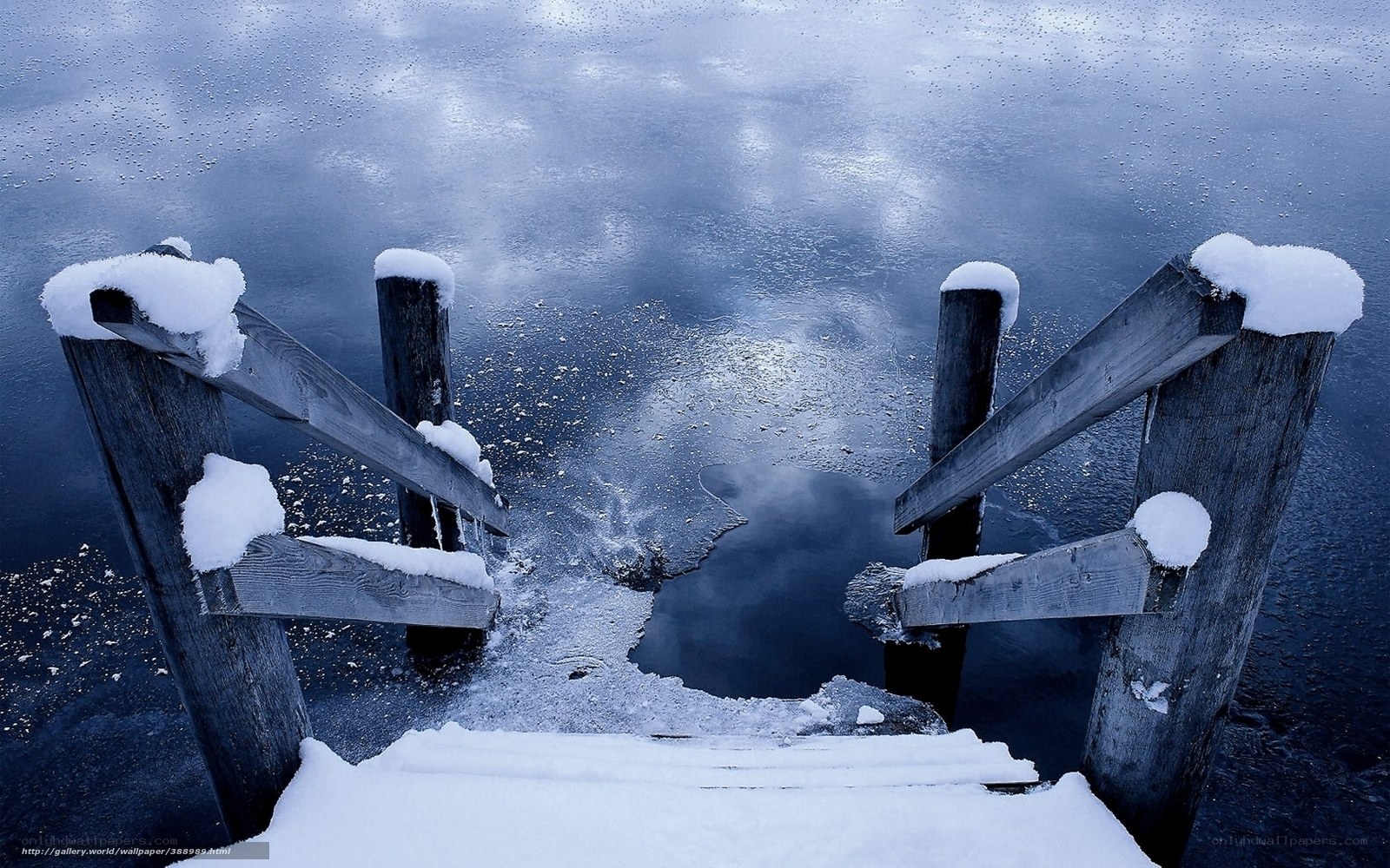 Snowy dock on frozen lake