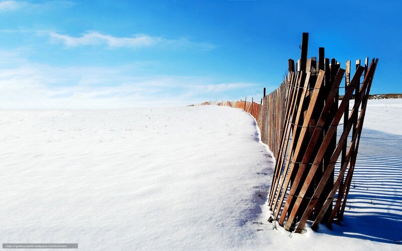 Snowy dunes with wooden fence