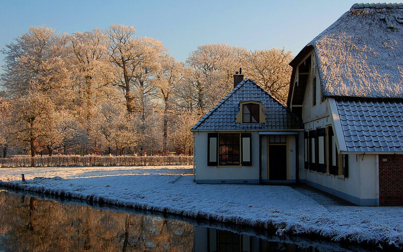 Snowy Dutch house by a canal