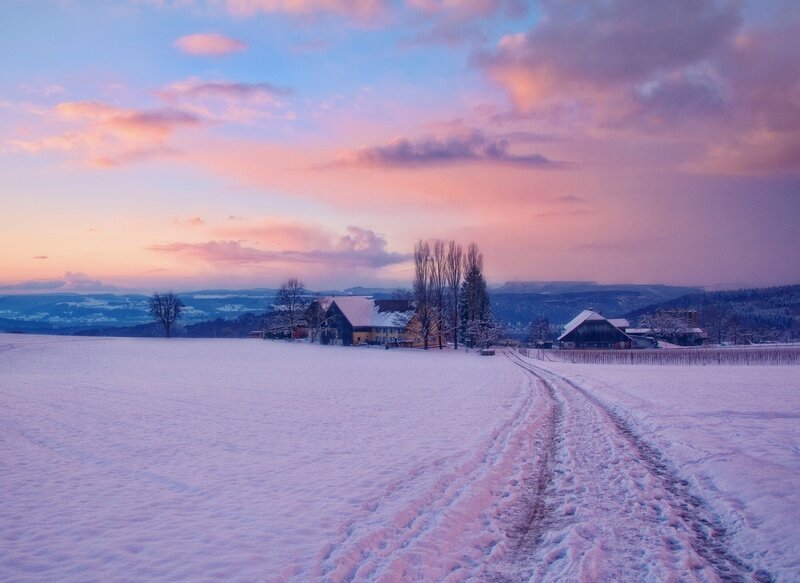 Snowy farm at sunset