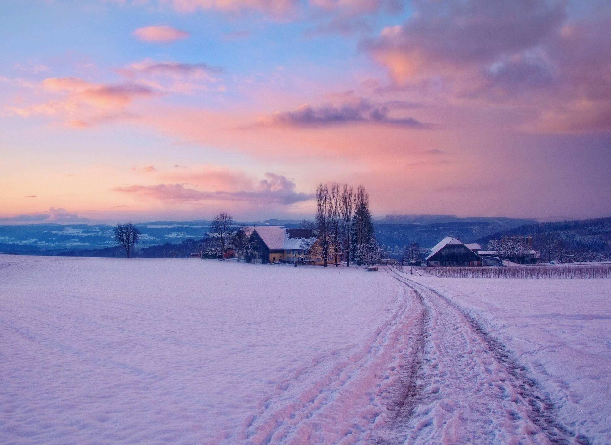 Snowy farm at sunset