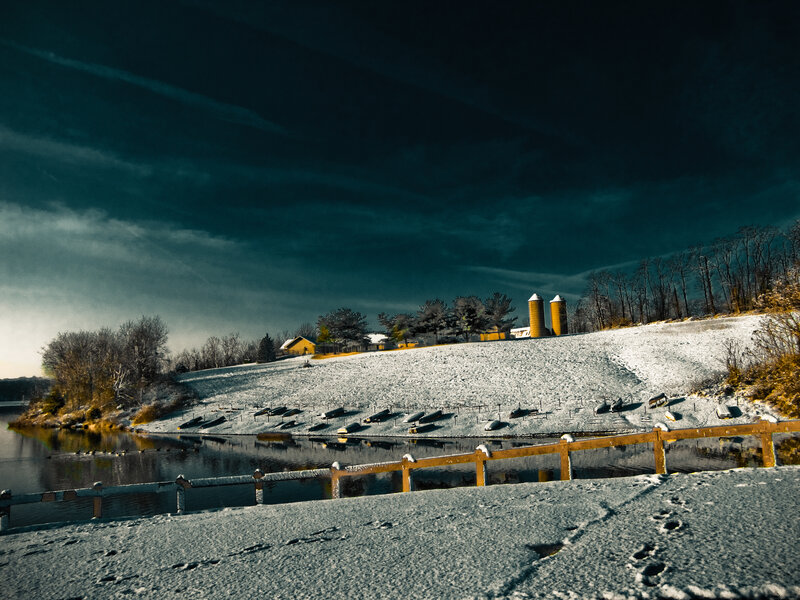 Snowy farm by the lake