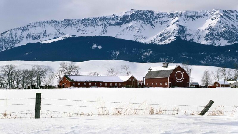 Snowy farm with mountains