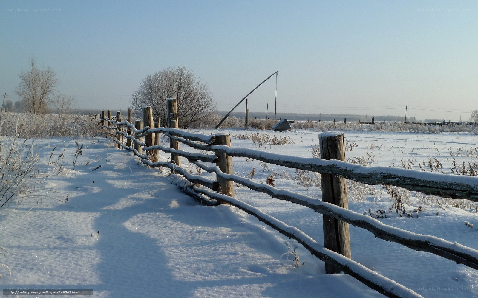 Snowy fence in winter landscape