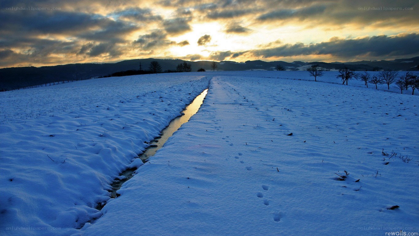 Snowy field at sunset