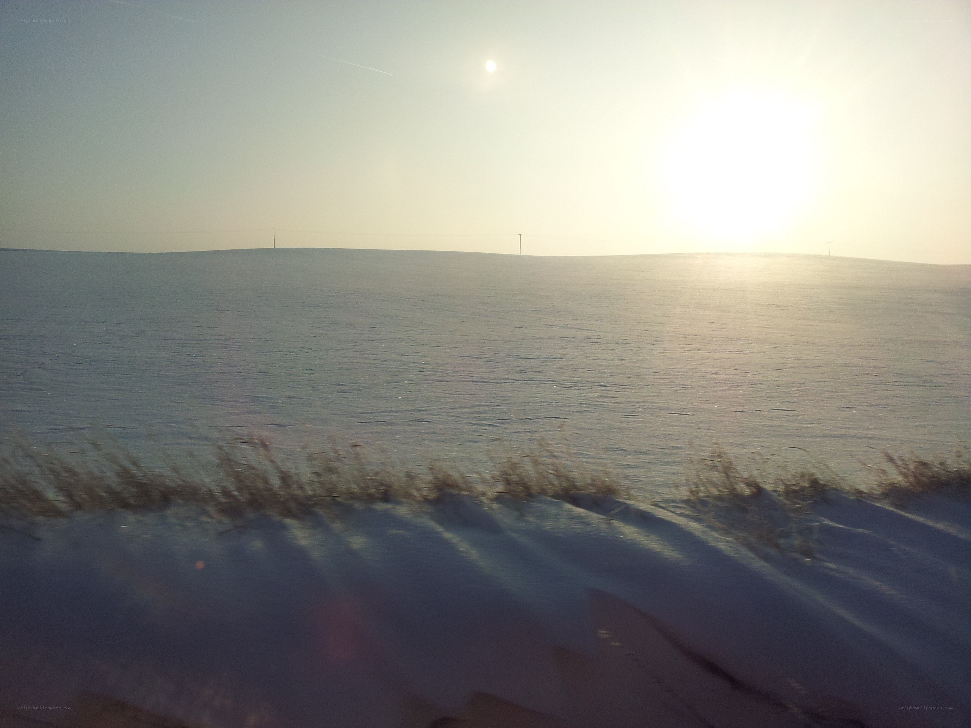 Snowy field at sunset