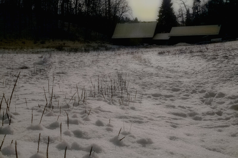 Snowy field with cabins