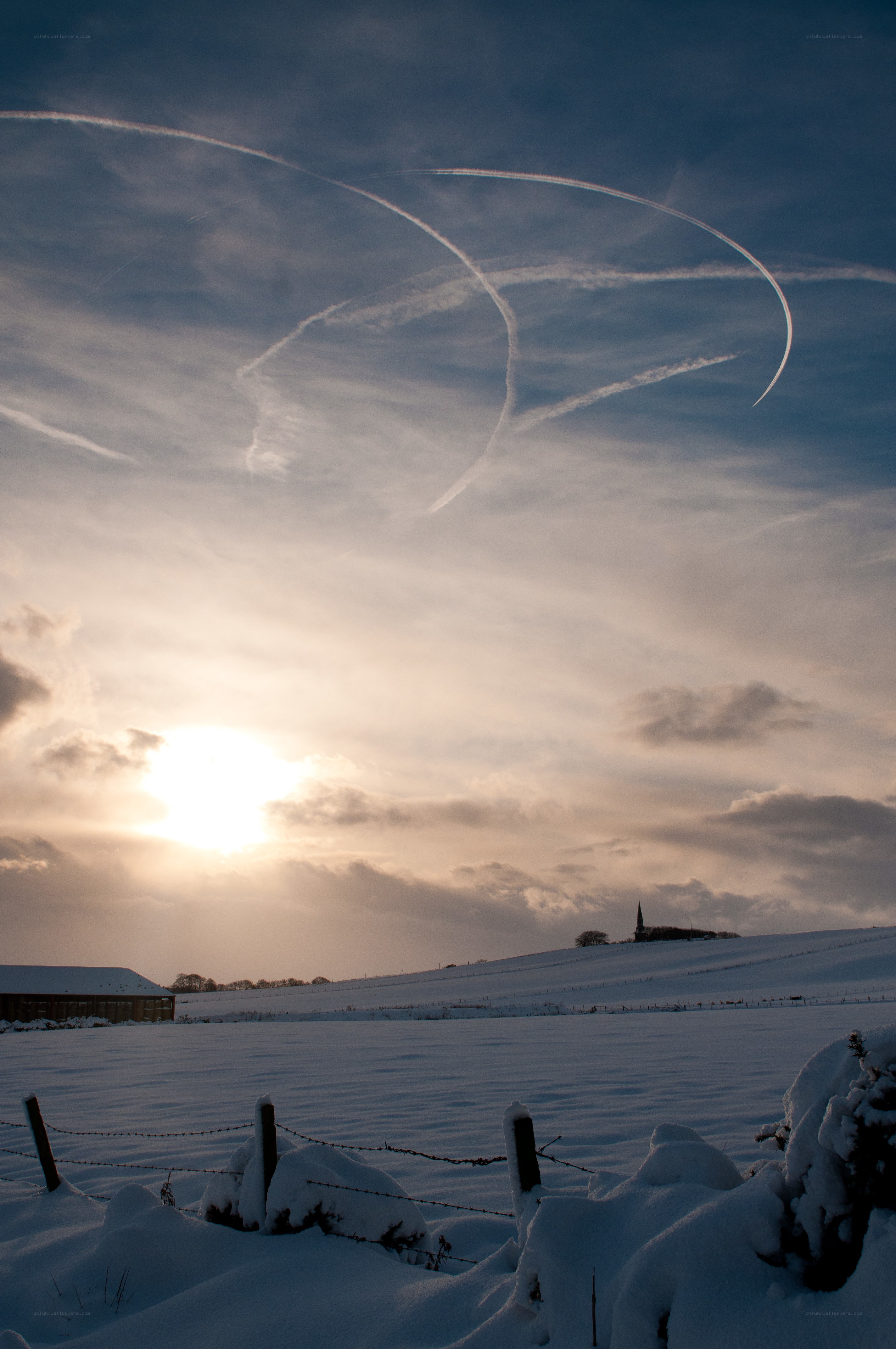 Snowy field with contrails
