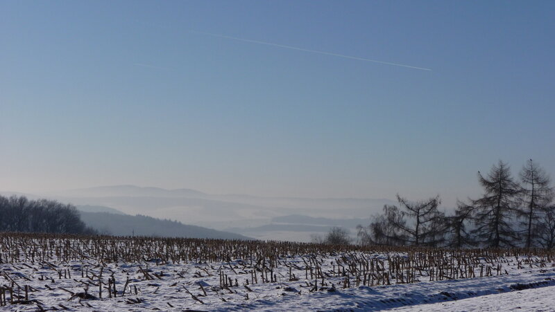 Snowy field with distant hills
