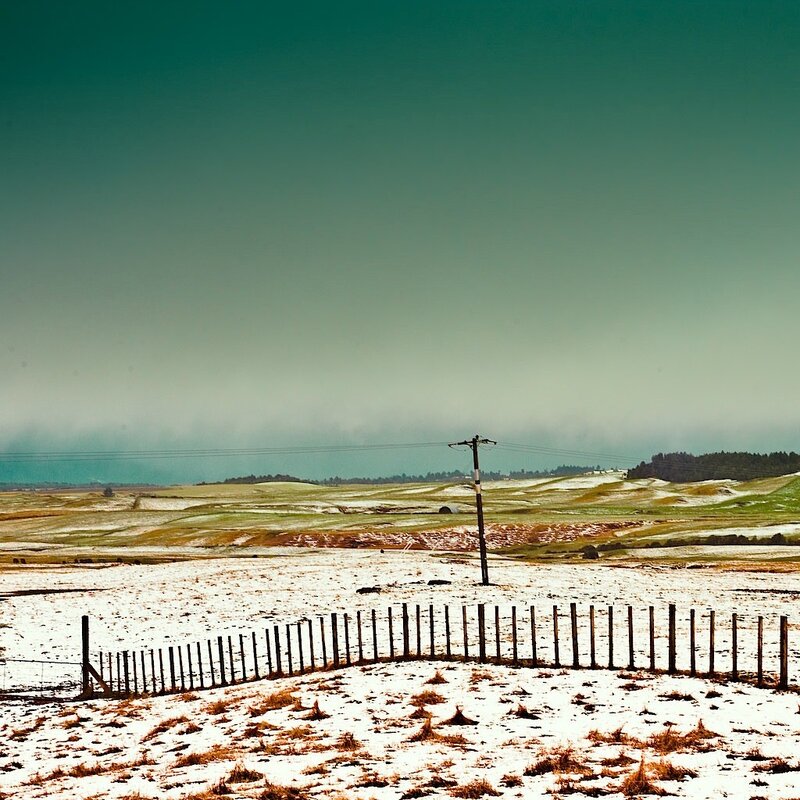 Snowy field with fence