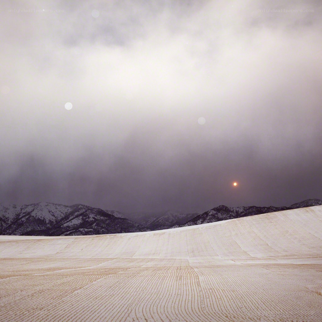 Snowy field with mountains