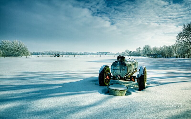 Snowy field with old tank
