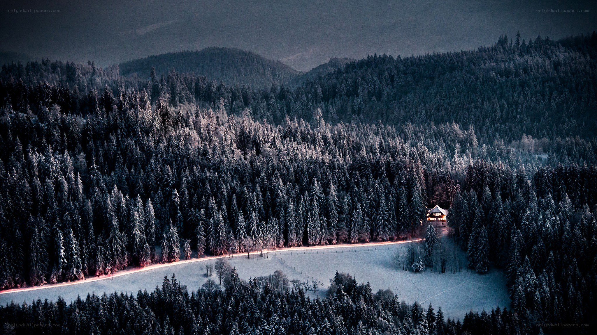 Snowy forest cabin at dusk