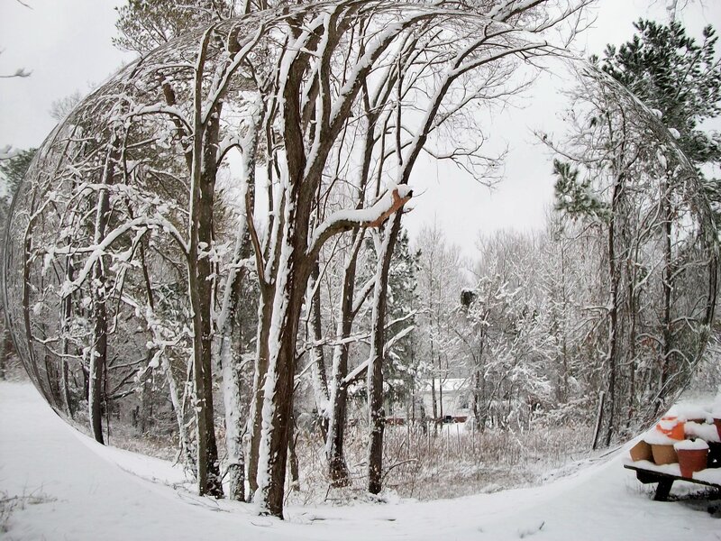 Snowy forest with reflective sphere
