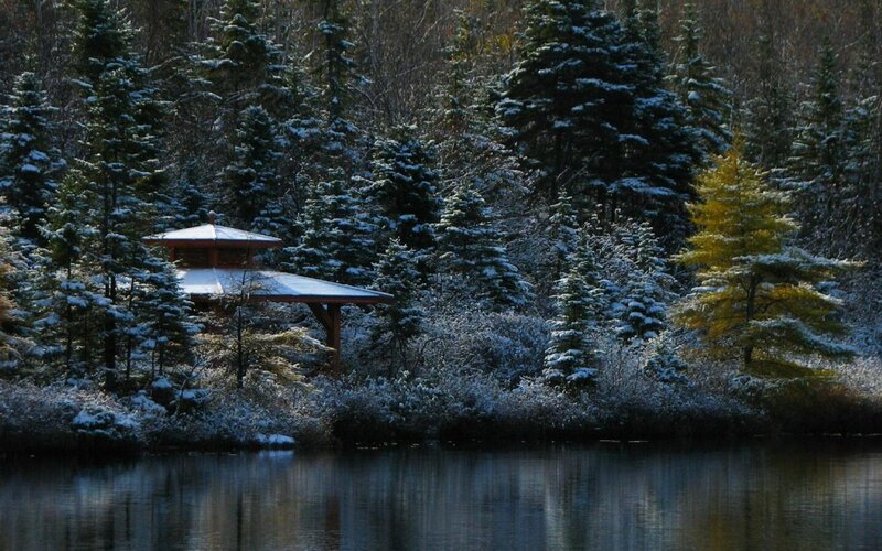 Snowy gazebo by a lake
