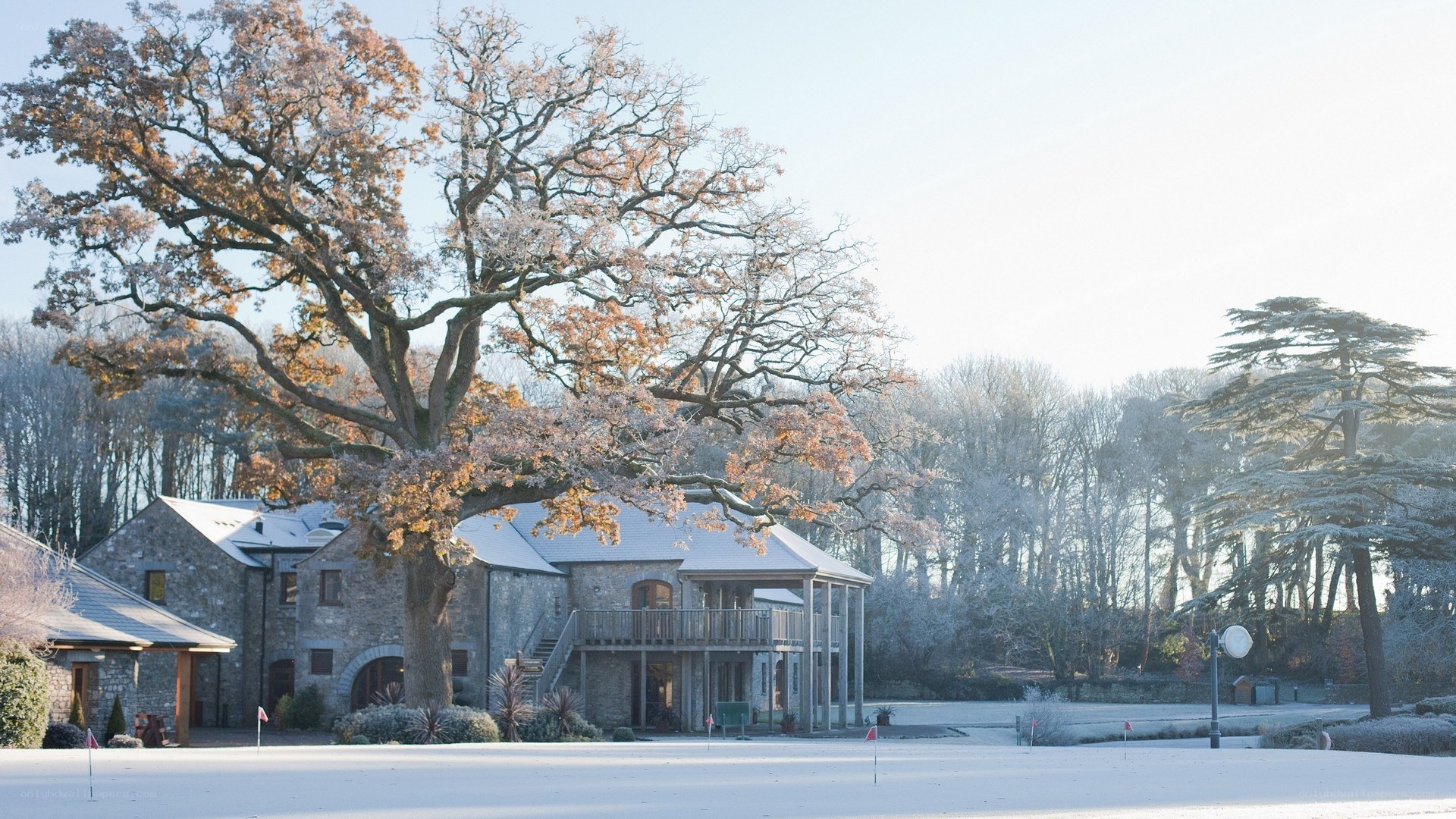 Snowy golf course with stone building