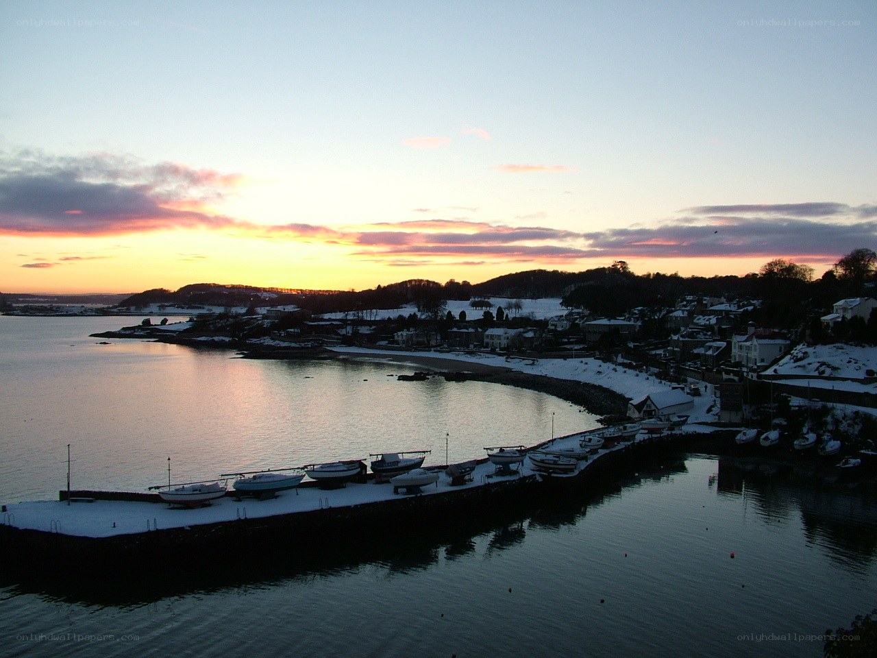 snowy harbor at sunset