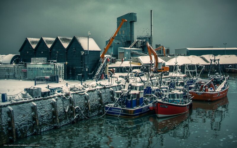Snowy harbor with fishing boats