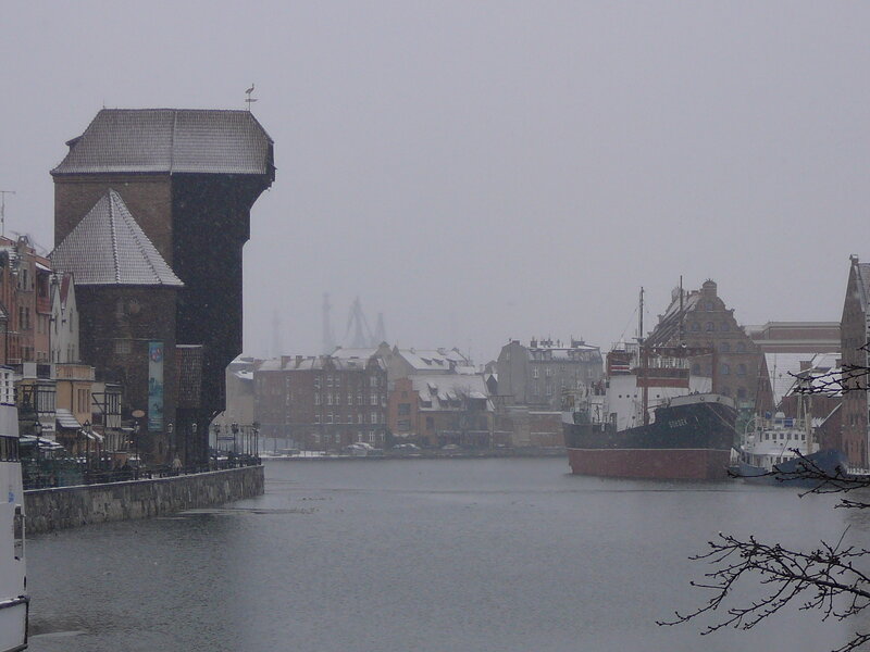 snowy harbor with historic crane