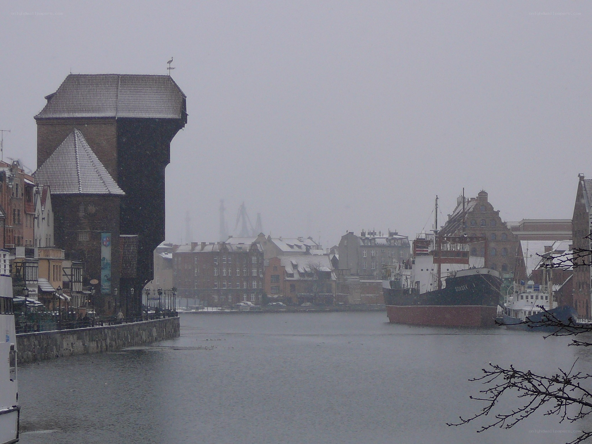 snowy harbor with historic crane