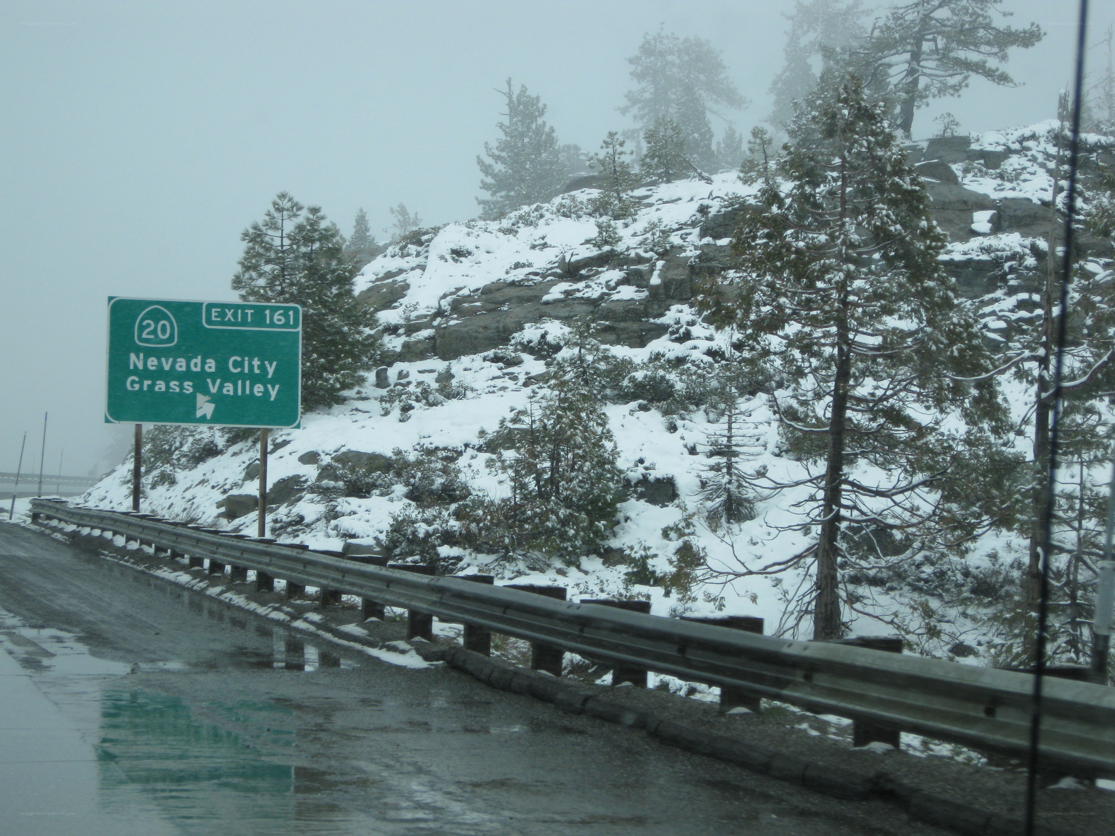 Snowy highway exit sign