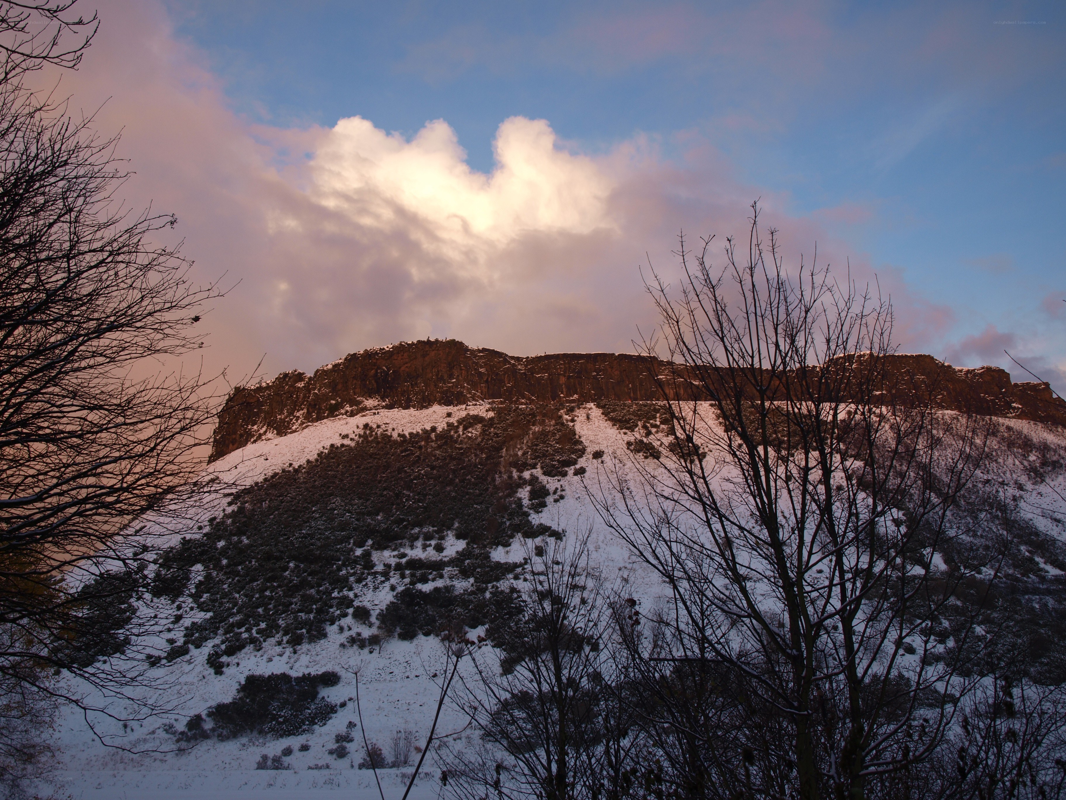 Snowy hill at sunset