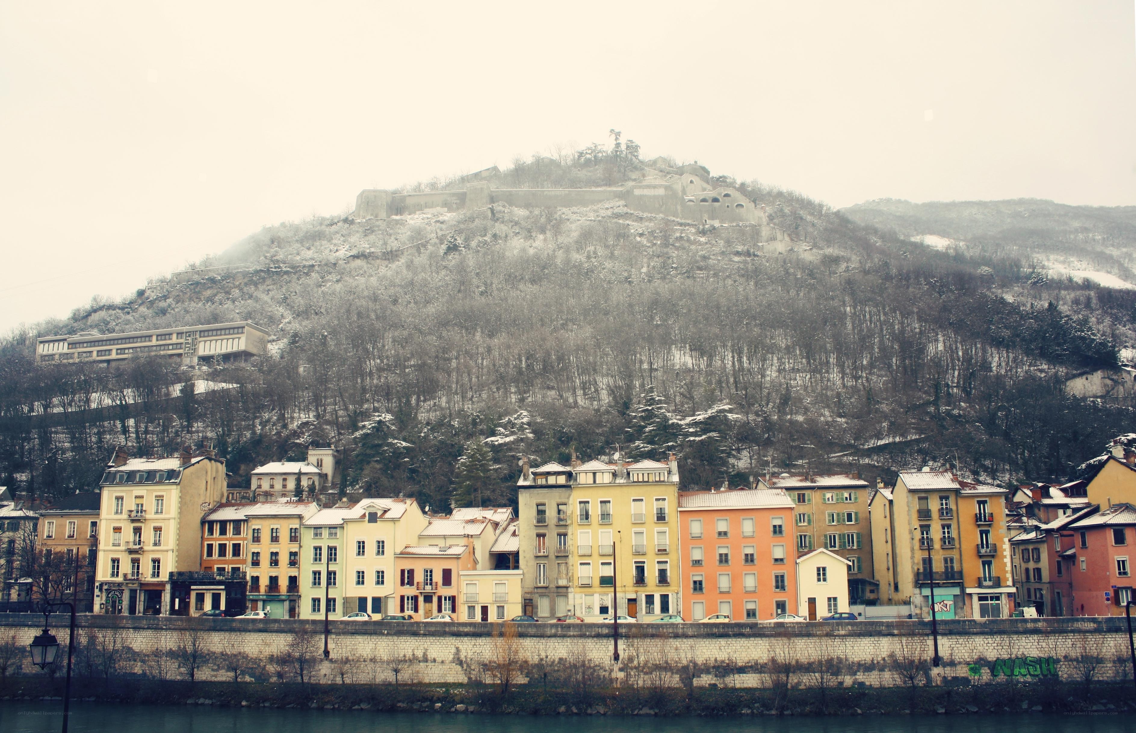 Snowy hillside town with fortress