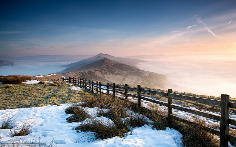 Snowy hilltop with foggy valley