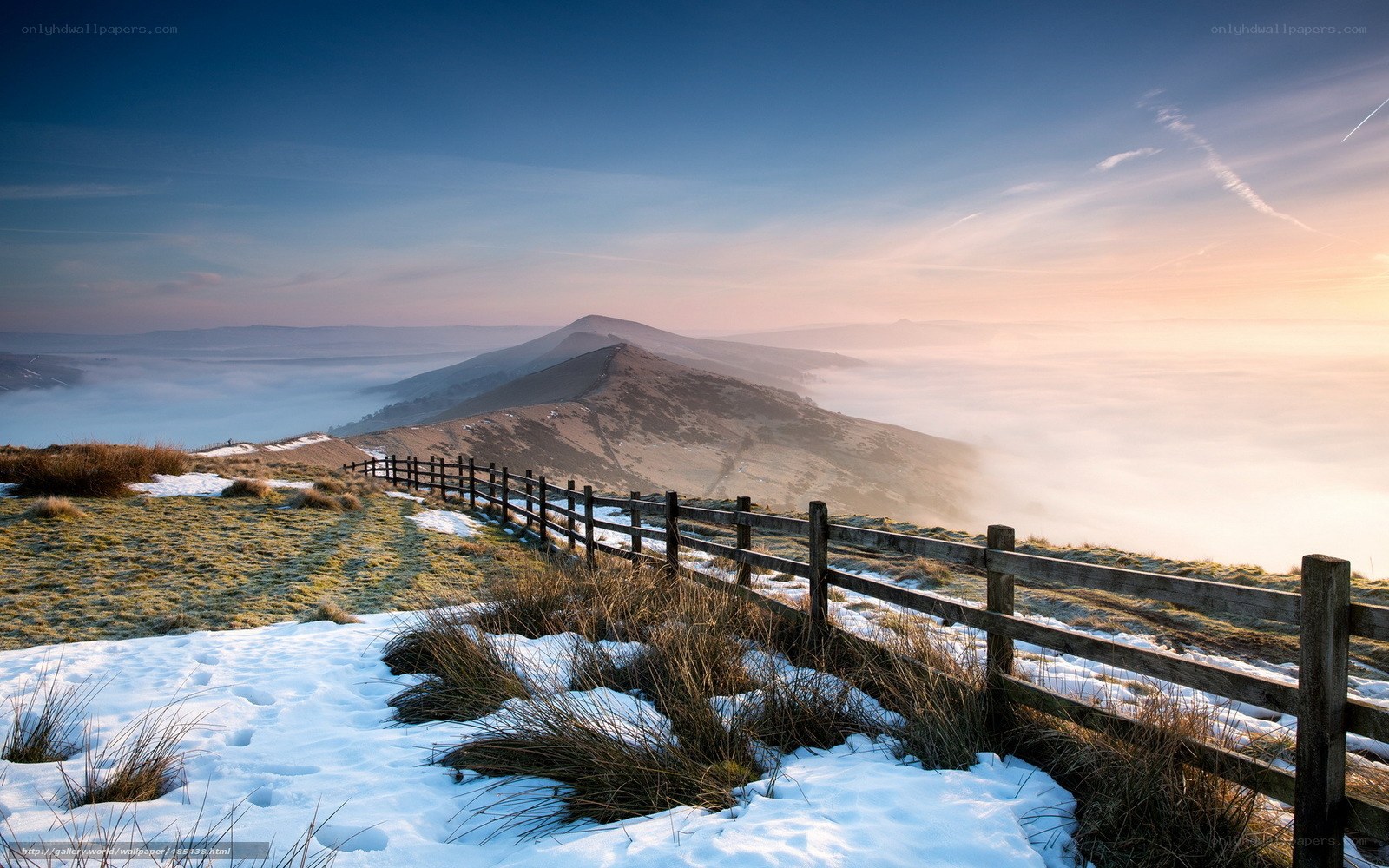 Snowy hilltop with foggy valley