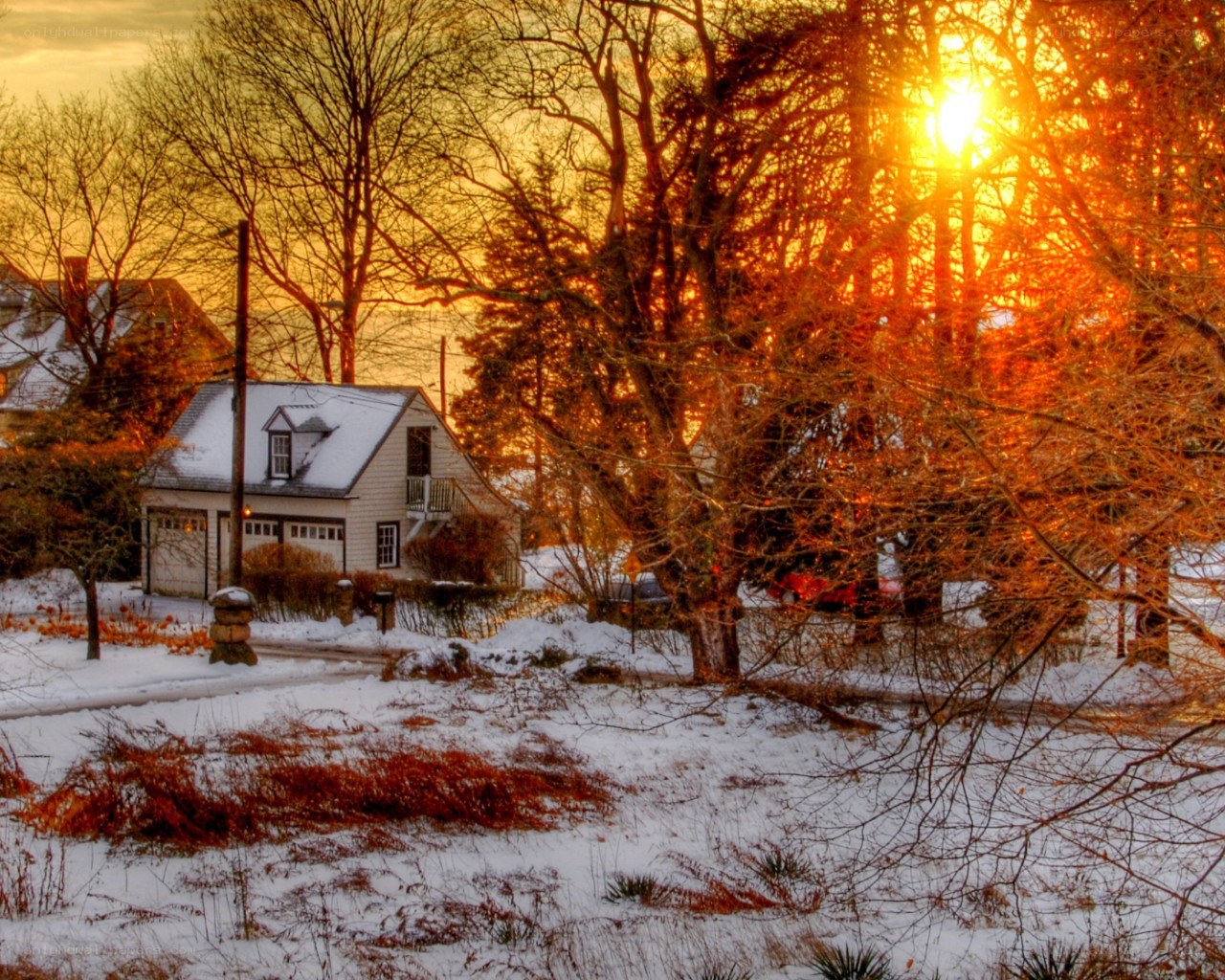 Snowy house at sunset