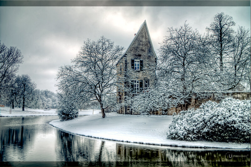 Snowy house by a river