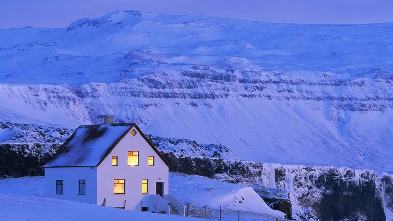 Snowy house in mountain landscape