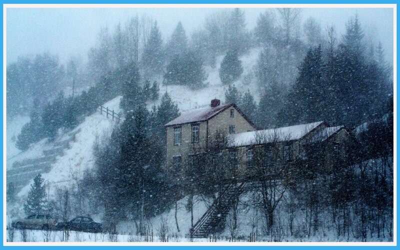 Snowy house on a hillside