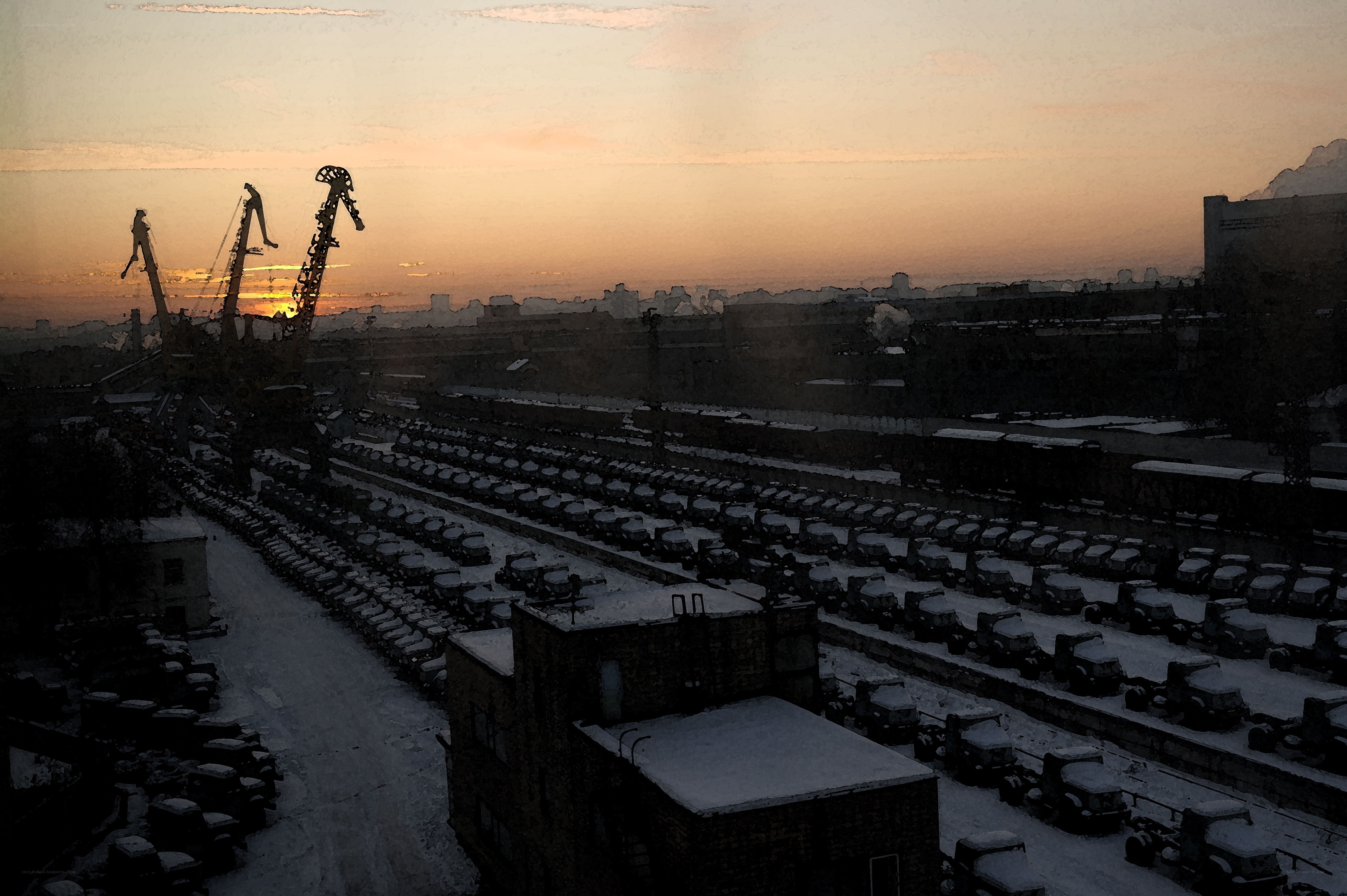 Snowy industrial yard at sunset