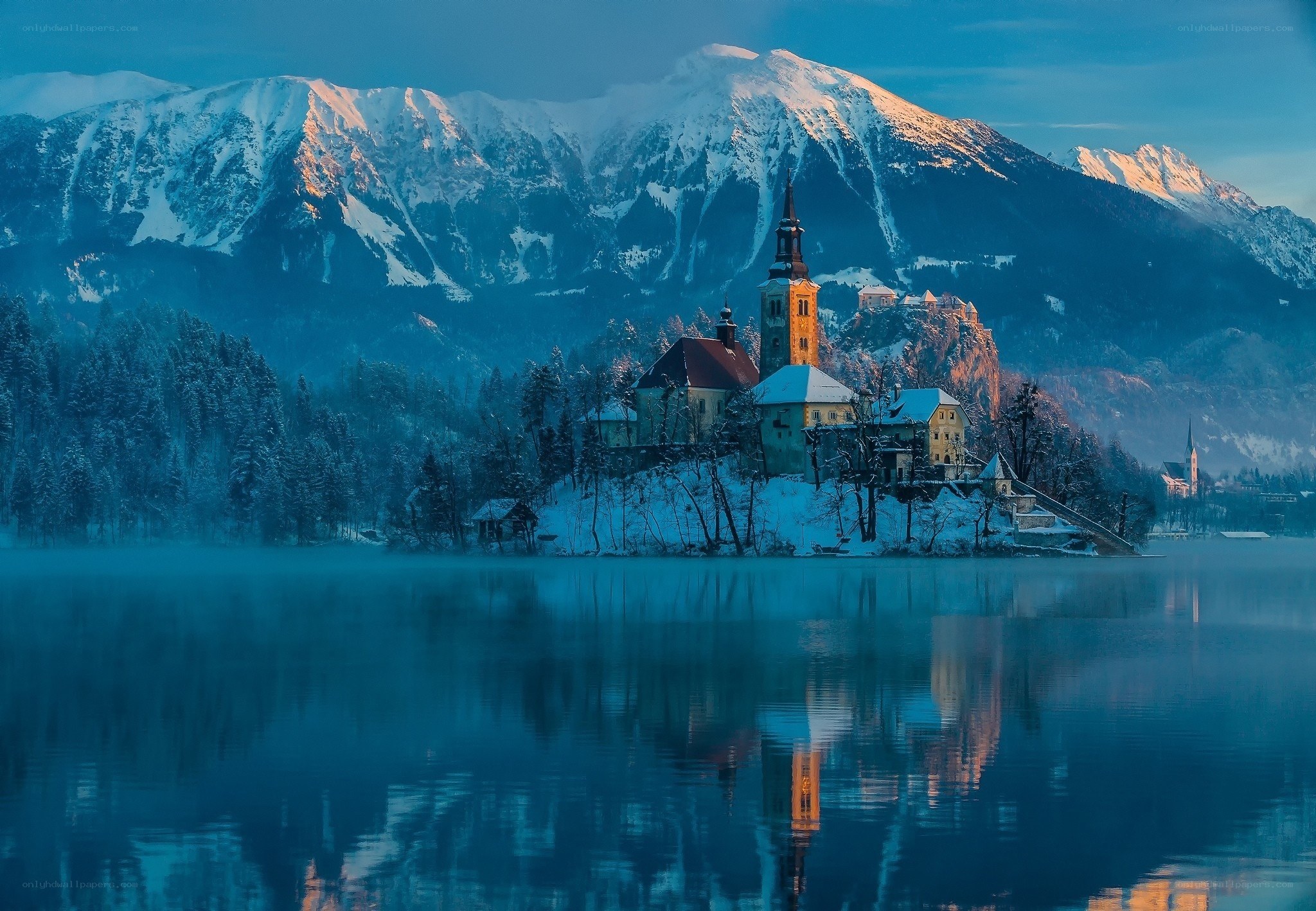 Snowy island church at dawn