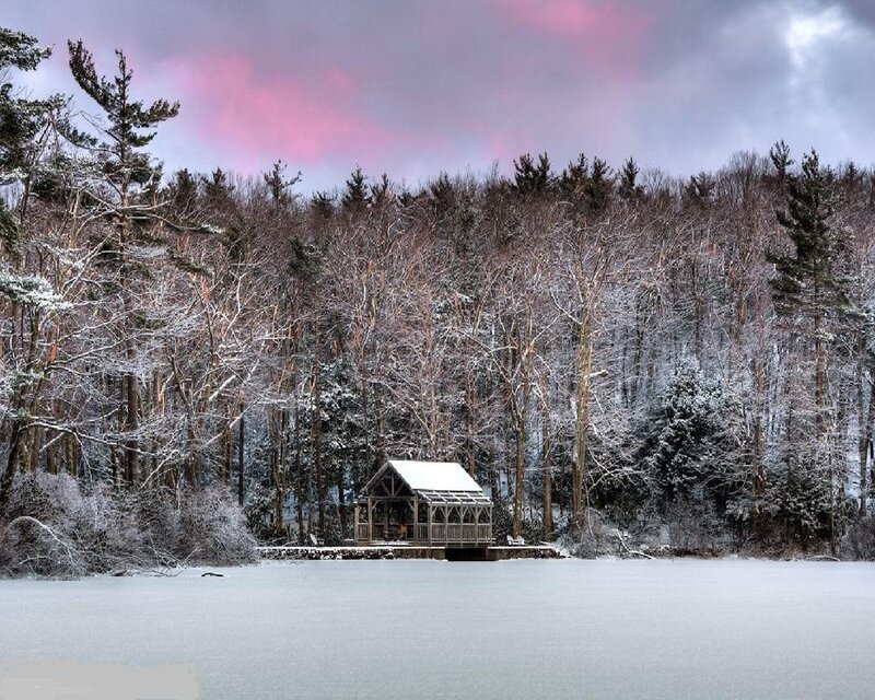 Snowy lake cabin at dusk