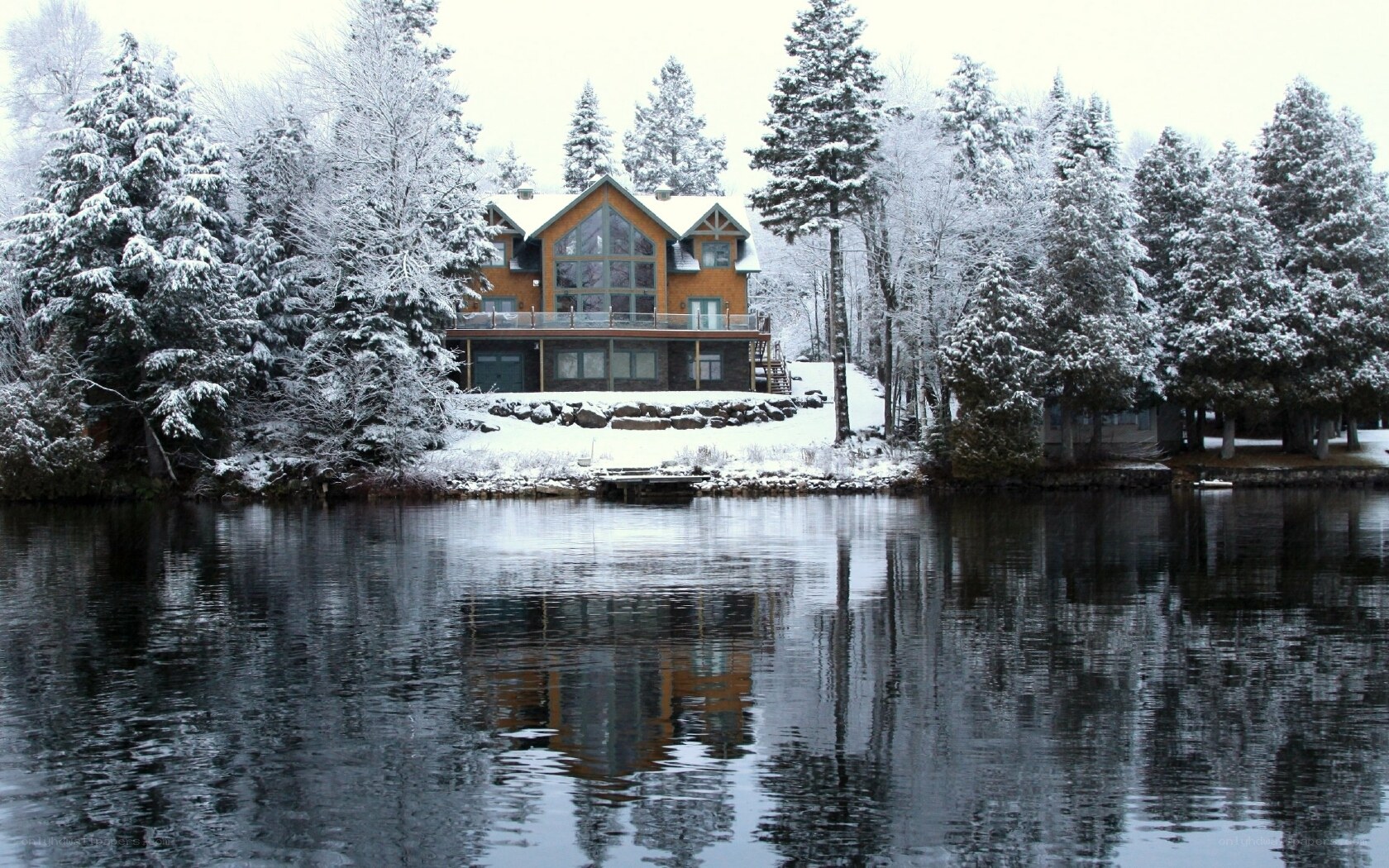 Snowy lake house in winter