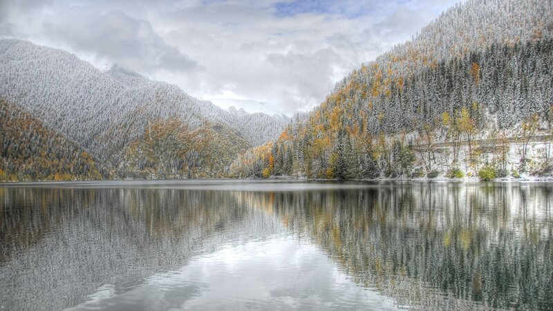 Snowy lake in autumn mountains