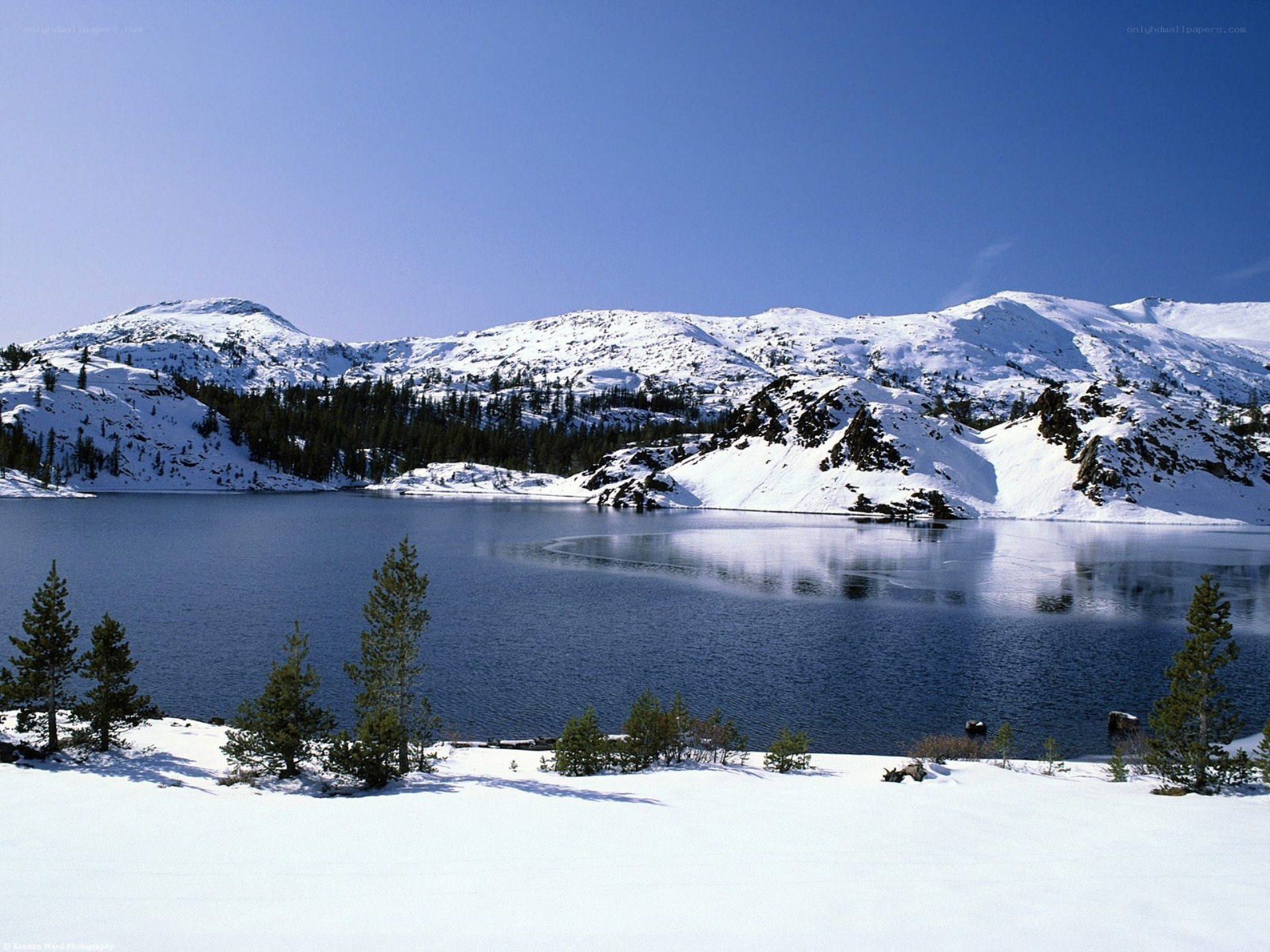 Snowy lake in mountain landscape