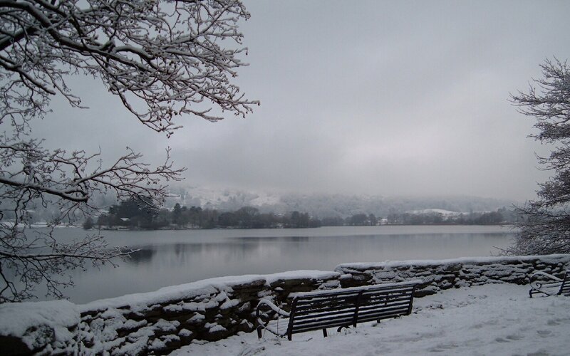 Snowy lake with bench