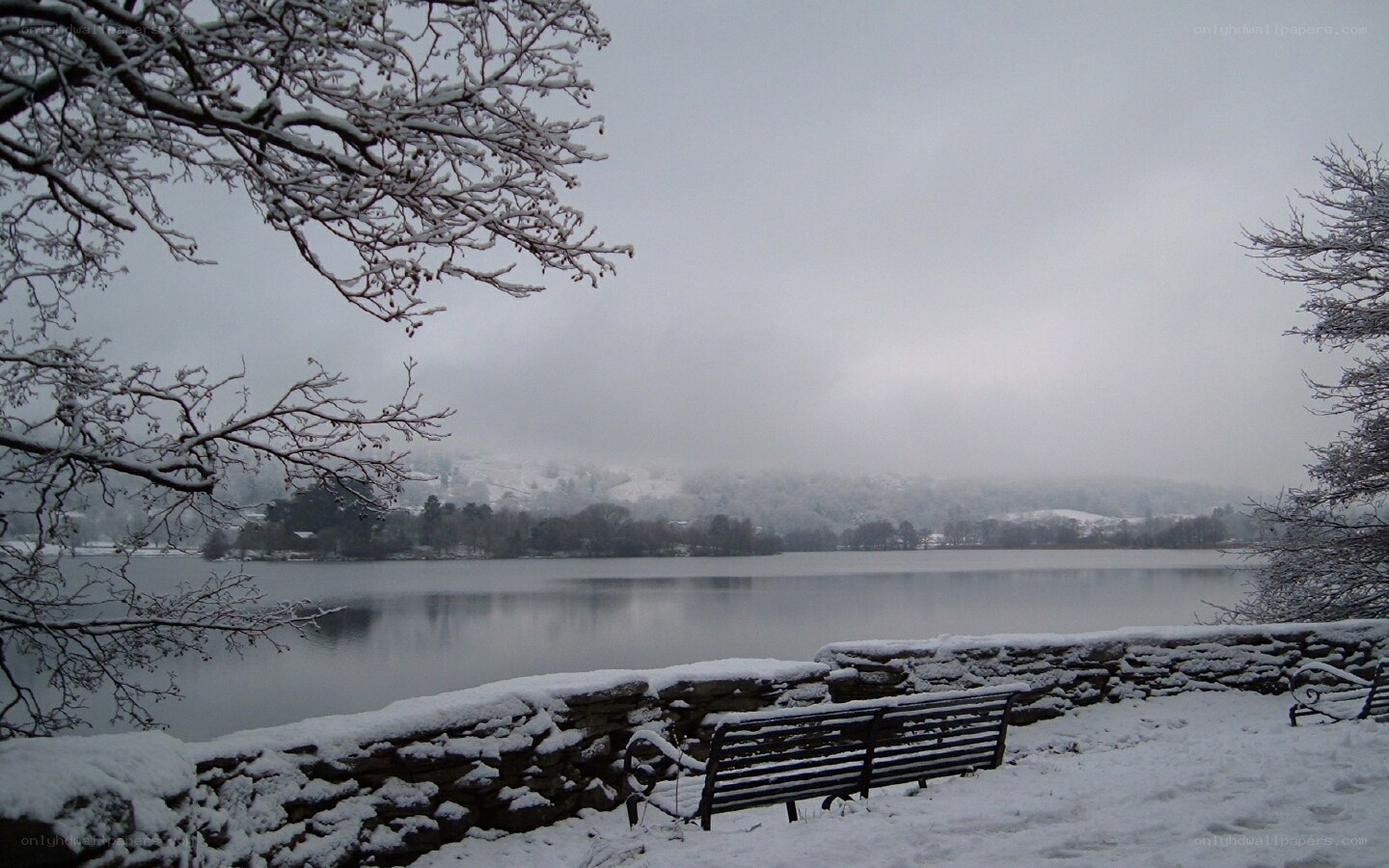 Snowy lake with bench