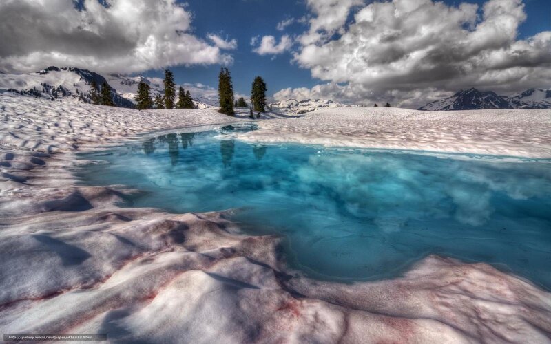 Snowy lake with blue water