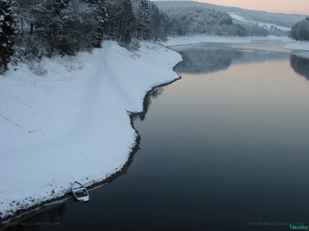 Snowy lake with boat