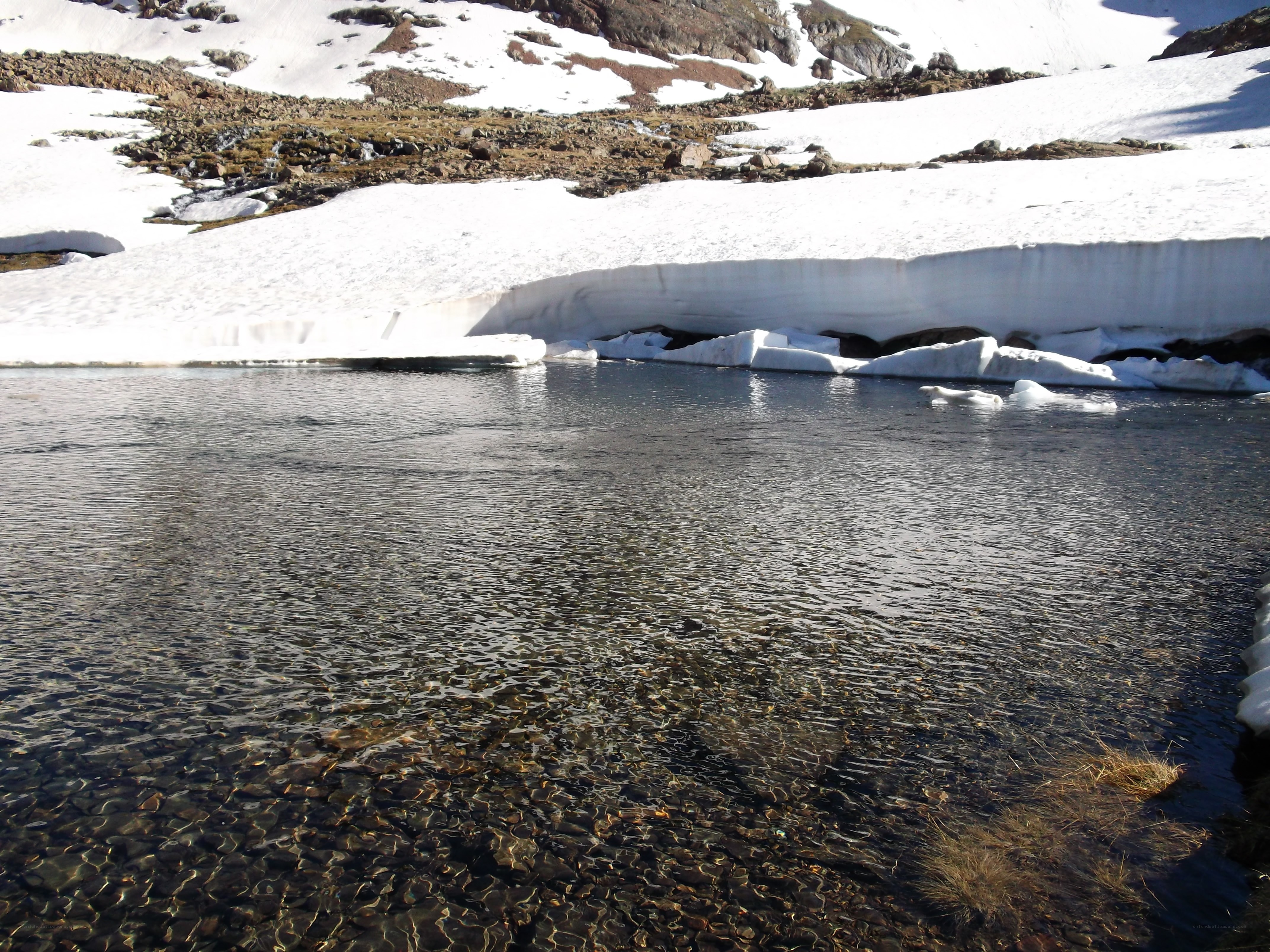 Snowy lake with clear water
