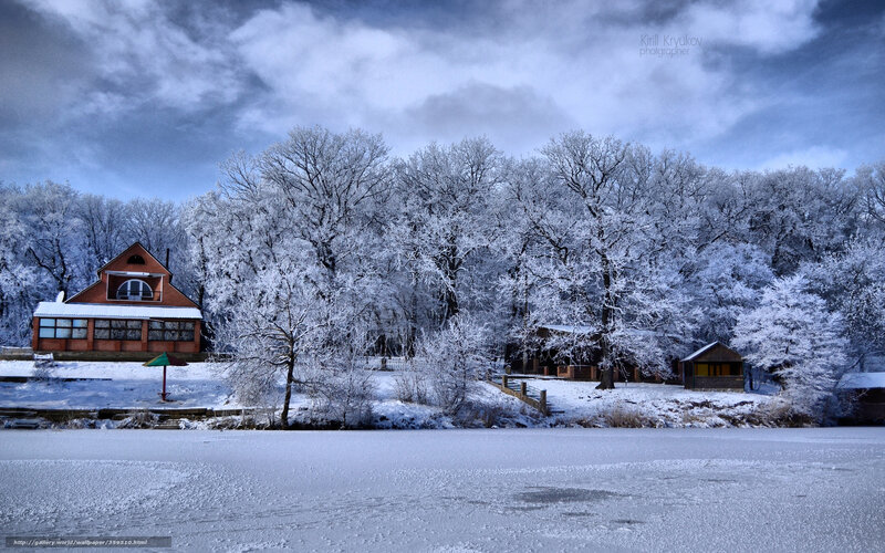 Snowy lake with forest and house
