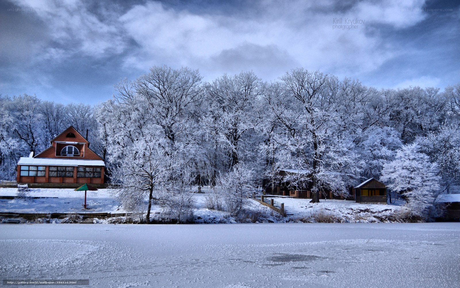 Snowy lake with forest and house